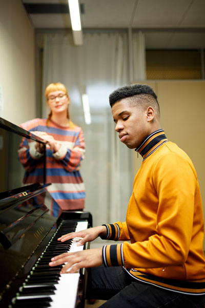 young man playing a piano